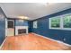 Inviting living room boasting hardwood floors, blue paneled walls, a fireplace, and classic design at 3230 Kingsfield Rd, Rock Hill, SC 29732