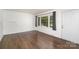 Bright, airy living room featuring hardwood floors, a large window, and a white front door at 3230 Kingsfield Rd, Rock Hill, SC 29732