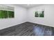 Bright bedroom featuring two windows and luxury vinyl flooring at 338 Orchard Trace Ln # 8, Charlotte, NC 28213