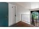 Hallway view featuring a white door with number 8 and black metal railing at 338 Orchard Trace Ln # 8, Charlotte, NC 28213