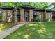 Charming brick condo building with well-maintained landscaping and a welcoming entrance at 338 Orchard Trace Ln # 8, Charlotte, NC 28213