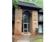 Attractive brick condo building with a unique archway entrance and exterior lights at 338 Orchard Trace Ln # 8, Charlotte, NC 28213