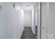 Hallway with luxury vinyl flooring and white doors at 338 Orchard Trace Ln # 8, Charlotte, NC 28213