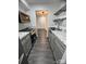 A galley kitchen showcasing granite countertops, gray cabinets, and stainless steel appliances at 338 Orchard Trace Ln # 8, Charlotte, NC 28213