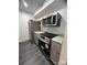 A modern kitchen featuring stainless steel appliances, gray cabinets, and granite countertops at 338 Orchard Trace Ln # 8, Charlotte, NC 28213