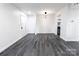 This living room has luxury vinyl flooring, fresh paint, and an updated light fixture at 338 Orchard Trace Ln # 8, Charlotte, NC 28213