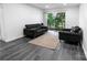 Well-lit living room features luxury vinyl flooring, and a sliding glass door to a balcony at 338 Orchard Trace Ln # 8, Charlotte, NC 28213