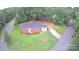 Aerial view of a brick home, lush greenery, and tree-lined streets at 346 Fieldstone Cir, Statesville, NC 28677