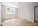 A bright bedroom with neutral walls, new flooring, and a large window at 346 Fieldstone Cir, Statesville, NC 28677