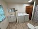 Bathroom with a sink, mirror, washer, dryer and toilet at 490 County Line Rd, Stony Point, NC 28678