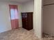 Simple bedroom with tiled floors and a dark dresser at 490 County Line Rd, Stony Point, NC 28678