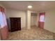 Simple bedroom with tiled floors and a dark dresser at 490 County Line Rd, Stony Point, NC 28678