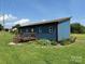 Home exterior with small deck and garden bed in a large yard at 490 County Line Rd, Stony Point, NC 28678