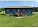 Cozy home showcasing a neatly maintained lawn and a welcoming front porch with steps at 490 County Line Rd, Stony Point, NC 28678