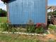 Close-up of the exterior with vibrant red lily plants along the base of the house at 490 County Line Rd, Stony Point, NC 28678