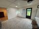 Neutral living room with an adjacent doorway, lots of natural light, and plank walls at 490 County Line Rd, Stony Point, NC 28678