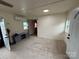 Neutral living room with modern split unit AC, lots of natural light, and an adjacent doorway at 490 County Line Rd, Stony Point, NC 28678