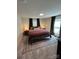 Comfortable bedroom with a metal bed frame, soft carpeting, and neutral decor at 512 S Gray St, Gastonia, NC 28052