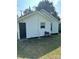 View of the home's rear exterior showcasing a door and barbecue grill at 512 S Gray St, Gastonia, NC 28052