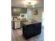 Stylish kitchen featuring olive cabinets, stainless steel appliances and wooden shelves at 512 S Gray St, Gastonia, NC 28052