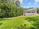 Exterior view of the home featuring a walkout basement, and spacious backyard at 5217 Waterfall Ct, Gastonia, NC 28056