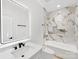 Modern bathroom featuring sleek vanity and bathtub with luxurious tile surround at 5217 Waterfall Ct, Gastonia, NC 28056