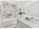 Modern bathroom with white marble backsplash, large mirror, single sink vanity, and luxurious soaking tub at 5217 Waterfall Ct, Gastonia, NC 28056