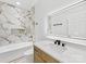 Modern bathroom featuring marble tile, dual vanity, and a soaking tub with shower at 5217 Waterfall Ct, Gastonia, NC 28056