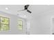 Bright bedroom featuring two windows, a modern fan, and a white door at 5217 Waterfall Ct, Gastonia, NC 28056