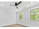 Bright bedroom with wood floors, custom wall decor, modern fan, and natural light from two windows at 5217 Waterfall Ct, Gastonia, NC 28056
