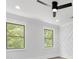 Bedroom featuring two windows for natural light, a fan, and modern trim at 5217 Waterfall Ct, Gastonia, NC 28056