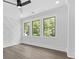 Bedroom boasting three windows, neutral paint, hardwood floors and modern ceiling fan at 5217 Waterfall Ct, Gastonia, NC 28056