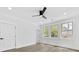 Bright bedroom with three large windows, neutral paint, modern ceiling fan, and sleek hardwood floors at 5217 Waterfall Ct, Gastonia, NC 28056