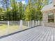 Spacious outdoor deck with white railings and views of the private wooded backyard at 5217 Waterfall Ct, Gastonia, NC 28056
