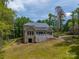 Back exterior featuring a brick facade, a spacious deck, and an attached garage at 5217 Waterfall Ct, Gastonia, NC 28056