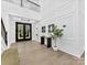 Bright foyer showcasing a black front door, wood floors, and decorative wall trim at 5217 Waterfall Ct, Gastonia, NC 28056