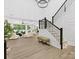 Staircase and living area boasting hardwood floors, natural light, and an open floor plan at 5217 Waterfall Ct, Gastonia, NC 28056