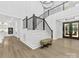 Stunning foyer featuring a staircase with black railings, hardwood floors, and natural light at 5217 Waterfall Ct, Gastonia, NC 28056