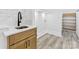 Well-lit laundry room featuring wood cabinets, stylish tile backsplash and floors at 5217 Waterfall Ct, Gastonia, NC 28056