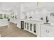 Elegant wet bar featuring white cabinetry, marble backsplash, under-cabinet refrigerator, and a sleek sink at 5217 Waterfall Ct, Gastonia, NC 28056