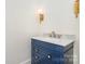 Elegant bathroom features a vanity with blue cabinet and gold fixtures at 530 E 9Th St, Charlotte, NC 28202