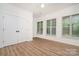 An empty bedroom with light hardwood floors, white trim and doors, and well lit by natural light at 530 E 9Th St, Charlotte, NC 28202