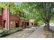 Red brick townhomes with tree-lined street and sidewalk at 530 E 9Th St, Charlotte, NC 28202