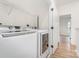 Bright laundry room with modern appliances and shelving for convenience and organization at 530 E 9Th St, Charlotte, NC 28202