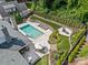 Aerial view of backyard with a pool, lounge chairs, landscaping, and outdoor seating areas at 5638 Timber Ln, Charlotte, NC 28270