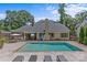 Backyard with a pool, lounge chairs, patio, landscaping, and outdoor dining areas at 5638 Timber Ln, Charlotte, NC 28270