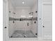 Bathroom featuring a glass-enclosed walk-in shower with dual shower heads and tiled walls at 5638 Timber Ln, Charlotte, NC 28270
