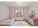 Charming bedroom with pink accents, wood flooring, and lots of natural light at 5638 Timber Ln, Charlotte, NC 28270