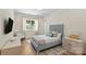 Bedroom features a light blue headboard, wood floors, and natural light from the large window at 5638 Timber Ln, Charlotte, NC 28270