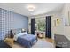 Bedroom with plaid wallpaper, gray bed, and window with natural light at 5638 Timber Ln, Charlotte, NC 28270